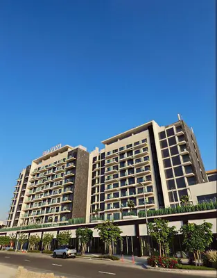 a large building with a car parked in front of it at Silk Valley - Luxury St with Pool Access & Balcony | 10 Min to Downtown in Dubai