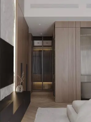a bedroom with a bed and wooden cabinets at Luxurious 3br apartment Dubai mall in Dubai