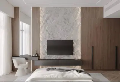 a bedroom with a bed and a tv on a wall at Luxurious 3br apartment Dubai mall in Dubai
