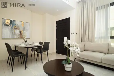 a living room with a couch and a table at Mira Holiday Homes - Spacious 3BDR Villa Stylish & Modern Comfort in Dubai