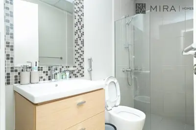 a bathroom with a sink and a toilet and a shower at Mira Holiday Homes - Spacious 3BDR Villa Stylish & Modern Comfort in Dubai