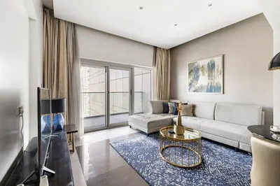 a living room with a couch and a table at Luxury Unit High Floor Damac Majestine in Dubai