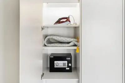 a closet with a door open with a scale on it at Luxury Unit High Floor Damac Majestine in Dubai