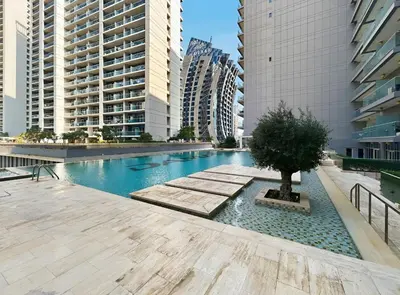 a swimming pool in a city with tall buildings at Luxury Unit High Floor Damac Majestine in Dubai
