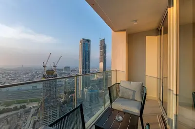 a balcony with a chair and a view of a city at 2BR Luxury Apartment in Downtown Opera in Dubai
