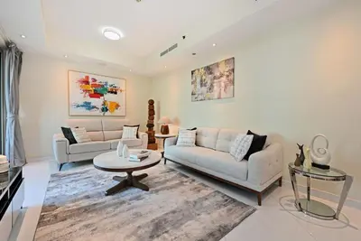 a living room with two couches and a table at Modern Luxury Upgraded 2BR Apartment The Greens in Dubai
