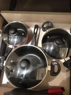 a group of pots and pans sitting on a stove at Luxury Furnished Studio with Alexa Automation JVC in Dubai