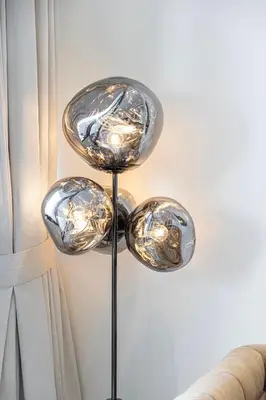 a lamp with four glass disks on a pole at Binghatti Phantom luxury living 5 stars amanities in Dubai