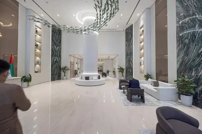 a person walking through a lobby of a building at Binghatti Phantom luxury living 5 stars amanities in Dubai