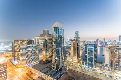 a city skyline at night with traffic at Walking Distance to Dubai Mall and Burj Khalifa, Easy Access to Dubai Marina, JBR Beach and Palm Jumeirah - Imperial Avenue, Downtown Dubai in Dubai