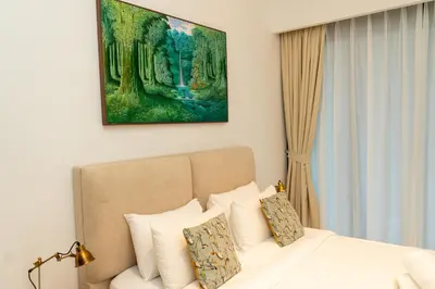 a bedroom with a bed and a painting on the wall at 1Luxury Newbedroom nearBusiness Bay in Dubai