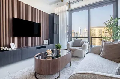 a living room with a couch and a tv at Frank Porter - Silverene Towers in Dubai