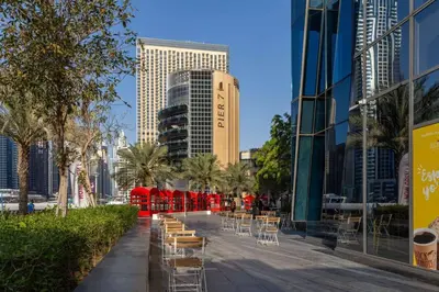 a street with chairs and tables in a city at Frank Porter - Silverene Towers in Dubai