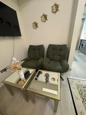 a living room with two chairs and a coffee table at Sophisticated Studio Designer Interiors in Dubai