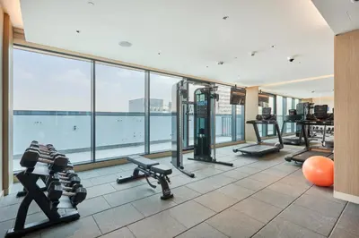 a gym with treadmills and exercise equipment in a building at STAY BY LATINEM Luxury 1BR Holiday Home CC 0913 Near Burj Khalifa in Dubai