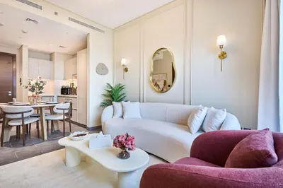 a living room with a couch and a table at STAY BY LATINEM Luxury 1BR Holiday Home CC 0913 Near Burj Khalifa in Dubai