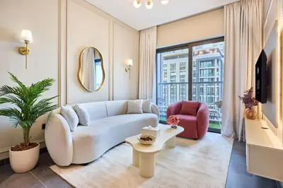 a living room with a couch and a chair at STAY BY LATINEM Luxury 1BR Holiday Home CC 0913 Near Burj Khalifa in Dubai