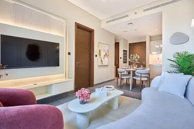 a living room with a large flat screen tv at STAY BY LATINEM Luxury 1BR Holiday Home CC 0913 Near Burj Khalifa in Dubai