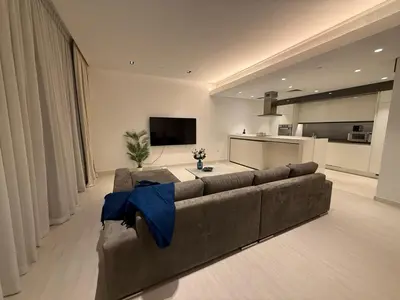 a large living room with a couch and a tv at Luxury Bluewaters Residence in Dubai