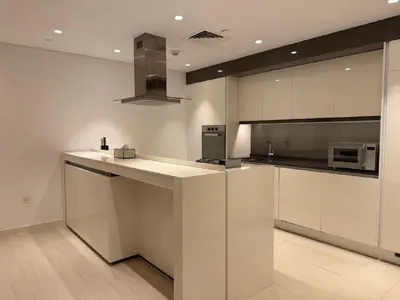 a kitchen with white cabinets and a counter top at Luxury Bluewaters Residence in Dubai