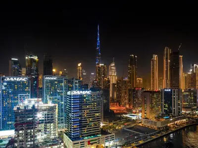 a night view of a city with a lit up skyline at Luxe studio Downtown Burj Khalifa Skyline view in Dubai