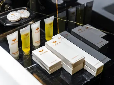 a table topped with three boxes and two glasses of wine at Luxe studio Downtown Burj Khalifa Skyline view in Dubai