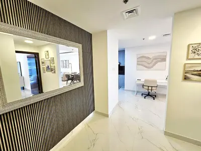a hallway with a mirror and a dining room at Beautiful 1-BR next to Barasti Beach in Dubai