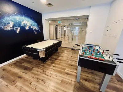 a room with a pool table and a foosball at Beautiful 1-BR next to Barasti Beach in Dubai