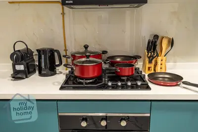 a stove with pots and pans on top of it at Luxury-Modern Apt with Theatre-Games-Pool-Gym in Dubai