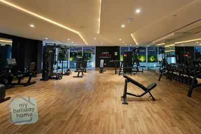 a gym with treadmills and exercise equipment in a building at Luxury-Modern Apt with Theatre-Games-Pool-Gym in Dubai