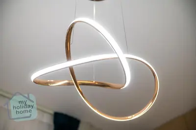 a metal towel rack with a happy holidays home sign at Luxury-Modern Apt with Theatre-Games-Pool-Gym in Dubai