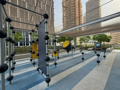 a metal structure with a yellow sign on a building at 21 Vida Dubai Mall 1 bedroom in Dubai