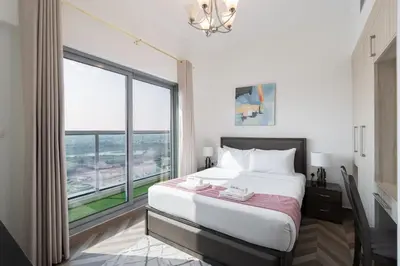 a bedroom with a large bed and a large window at Elegant 2BR - Top Amenities - Elite Business Bay in Dubai