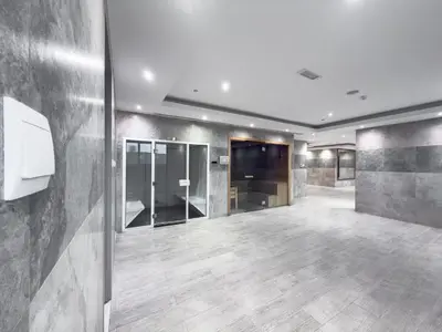 an empty lobby with glass doors and wooden floors at Elegant 2BR - Top Amenities - Elite Business Bay in Dubai