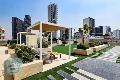 a gazebo in a park with a city at Modern 1BR Apt - Parking - Gym - Play Area in Dubai