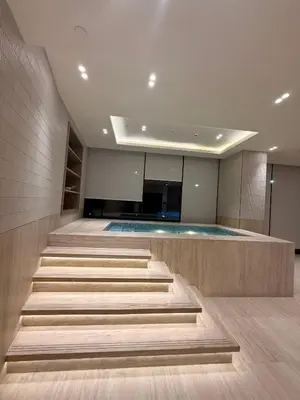 a swimming pool with stairs in a building at The Royale Beige Jacuzzi Suite 36 2-4 I JVC I Dar Oasis in Dubai