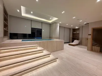 a lobby with stairs and a swimming pool at The Royale Beige Jacuzzi Suite 36 2-4 I JVC I Dar Oasis in Dubai