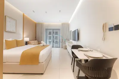 a hotel room with a bed and a dining table at Studio with Seamless Mall Access, Steps from the Bus Stop, Binghatti Stars, Dubai Silicon Oasis by Deluxe Holiday Homes in Dubai