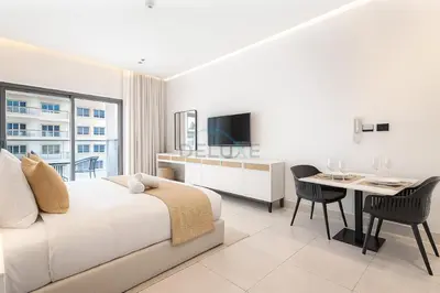 a bedroom with a bed and a desk and a table at Studio with Seamless Mall Access, Steps from the Bus Stop, Binghatti Stars, Dubai Silicon Oasis by Deluxe Holiday Homes in Dubai