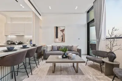 a living room with a couch and a table at Private Pool - Amazing 1BR Apartment in JVC in Dubai