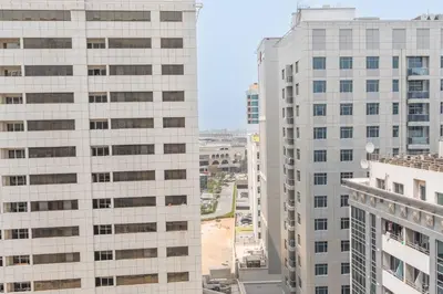 a view of two tall buildings in a city at StayShort - Roomy 2BR in Al Barsha with Balcony - Sleeps 4 in Dubai