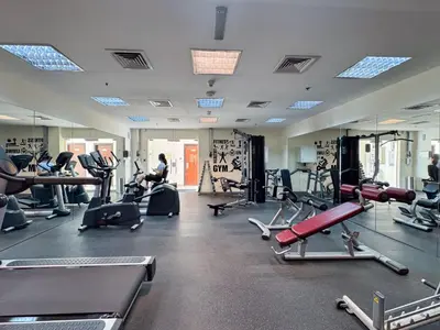 a gym with lots of treadmills and exercise bikes at StayShort - Roomy 2BR in Al Barsha with Balcony - Sleeps 4 in Dubai