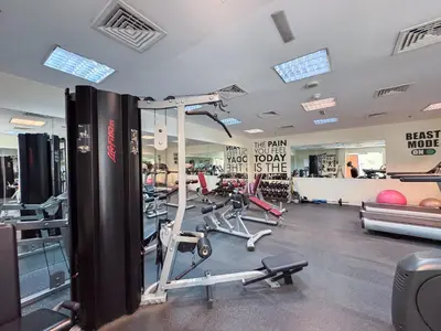 a gym with several treadmills and exercise bikes at StayShort - Roomy 2BR in Al Barsha with Balcony - Sleeps 4 in Dubai