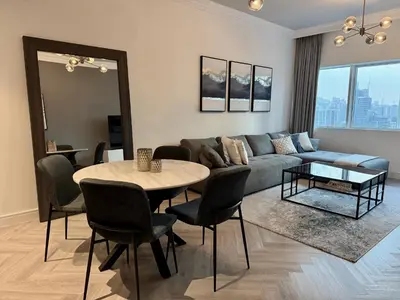 a living room with a couch and a table at Casa Marina - great views & pool, fully equipped in Dubai