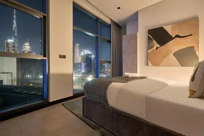 a bedroom with a bed and a view of the city at Premium 15 Northside Residences in Business Bay, Close to Downtown Dubai & Burj Khalifa by Stayfinity in Dubai