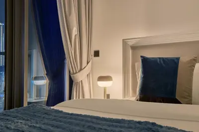 a bedroom with a bed with a blue pillow and a window at Premium 15 Northside Residences in Business Bay, Close to Downtown Dubai & Burj Khalifa by Stayfinity in Dubai