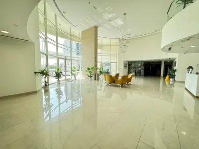 an empty lobby with a couch and chairs in a building at Studio near Marina - 15mins drive in Dubai