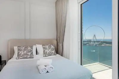 a hotel room with a bed with towels on it at La Vie Apartments in Dubai
