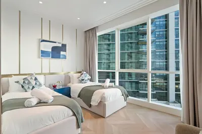 a hotel room with two beds and a large window at Luxurious 2BR Breathtaking Huge Pool & Sea Views in Dubai