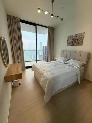 a bedroom with a large bed and a large window at Luxury 1BR Apartment In Binghatti Corner, High Floor In JVC in Dubai
